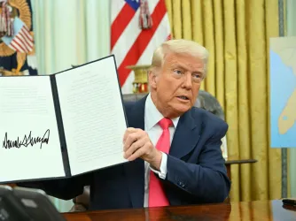 President Donald Trump signing an executive order in the Oval Office of the White House on March 6, 2025